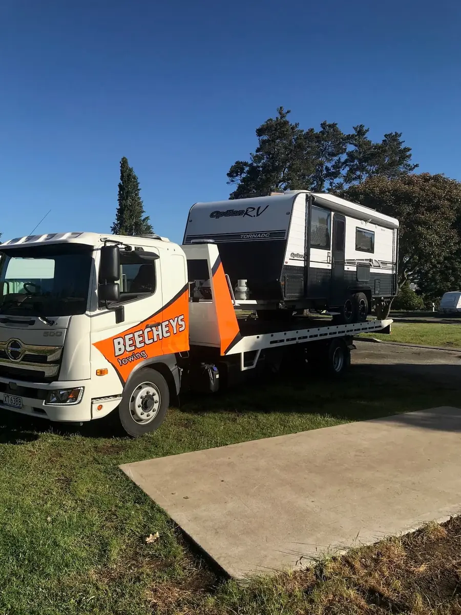 Beecheys Towing truck towing an Option R.V. caravan on a Launceston street