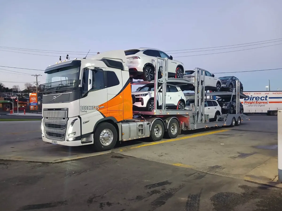 A Beecheys Towing flatbed carrying a customer vehicle