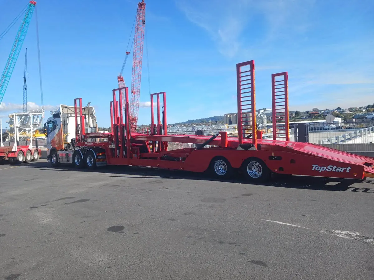 Beecheys Towing carrying heavy equipment on a trailer
